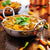curry bowl in a balti dish with coriander garnish
