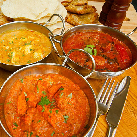 three curry dishes pakora and papad using ajwain seeds