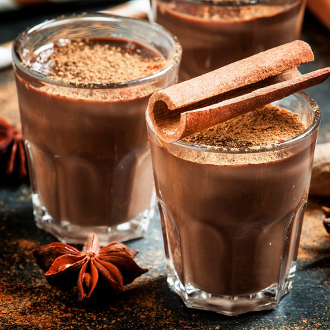 hot sweet chocolate drink garnished with cinnamon and apple pie spice