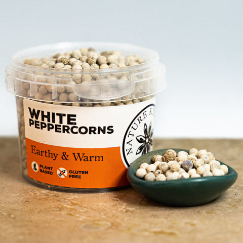 White peppercorns in a pot